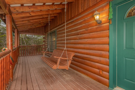 Porch swing at Pigeon Forge Pleasures, a 3 bedroom cabin rental located in Pigeon Forge