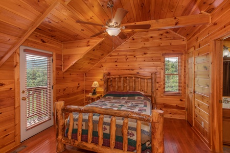 Queen bedroom on the upper floor with en suite bath at Four Seasons Lodge, a 3-bedroom cabin rental located in Pigeon Forge