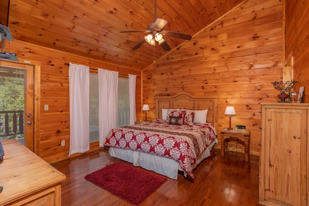 Bedroom with a king-sized bed and two end tables at Cabin Fever, a 4-bedroom cabin rental located in Pigeon Forge