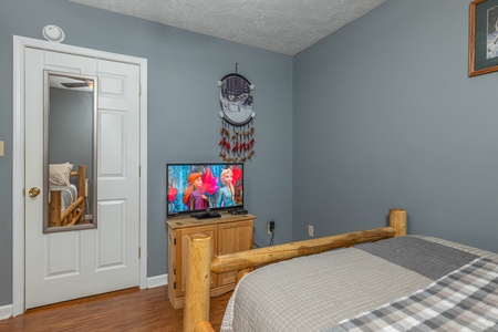 Dresser and TV in a bedroom at Wildlife Retreat, a 3 bedroom cabin rental located in Pigeon Forge