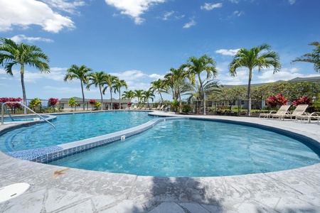 Stylish resort pool with curved design and ocean views.
