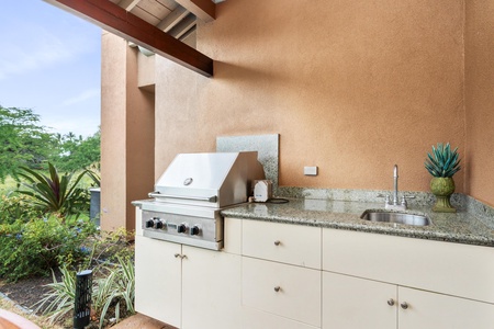 Step into your private outdoor kitchen where granite countertops and professional-grade appliances await your culinary adventures under the open sky.
