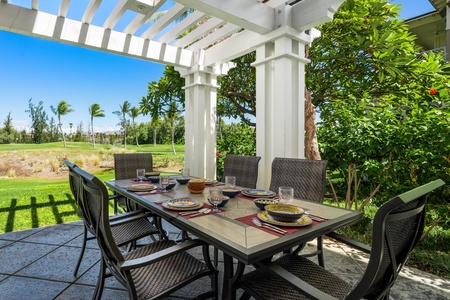 - Dine al fresco under the shaded pergola with seating for six and a scenic backdrop - Table set for memorable meals with colorful dishware and glassware - Perfect spot for breakfast in the breeze or sunset dinners outdoors