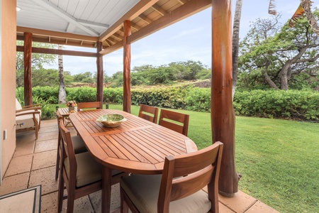 Your private covered terrace features warm teak dining for six, overlooking lush tropical gardens where you'll savor meals surrounded by nature.