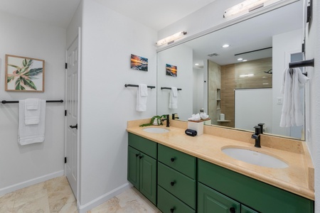 Bathroom features a double vanity with lots of cabinetry.