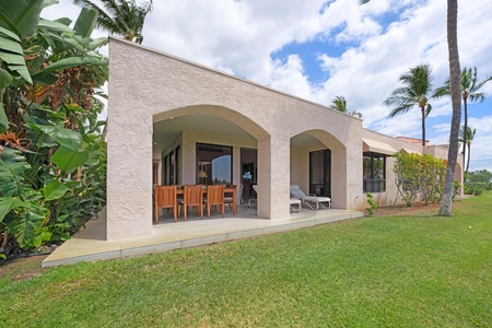 - Spacious backyard with covered patio ideal for dining lounging or outdoor fun - Arched design creates a stylish flow from the lawn to the indoor areas - Surrounded by palm trees and open skies with easy indoor outdoor access