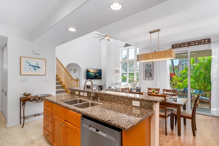 Granite countertops and double sink overlook the bright living space.