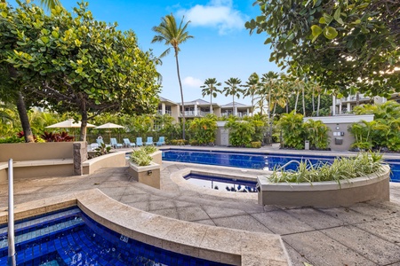 A sparkling pool area surrounded by lush tropical palms.