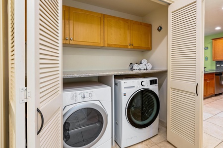 In unit laundry features full size washer and dryer tucked neatly in a closet.