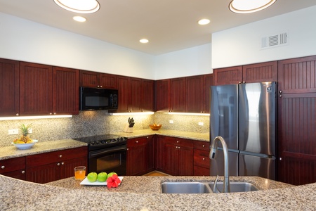 - Spacious kitchen with granite counters, rich wood cabinets, and sleek stainless appliances - Microwave, oven, and fridge ready for every cooking need - Bright lighting and modern finishes create a warm inviting feel