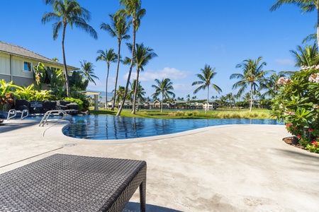Poolside relaxation with lounge seating under sunny skies.