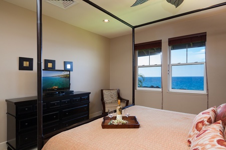 - Unwind with your favorite show from bed while gazing out at endless ocean views - Sleek dresser, tray with wine, and warm wood finishes elevate your island stay - Natural light and thoughtful touches make this space a guest favorite