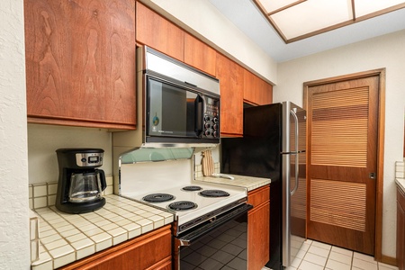 Your fully equipped kitchen features warm wood cabinetry, modern appliances, and everything you need to create delicious home-cooked meals.