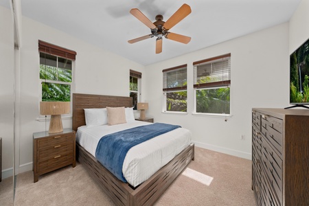 Drift off in your serene bedroom sanctuary, where warm wood tones and tropical views create the perfect retreat for restful nights.