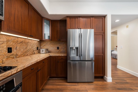 Your gourmet kitchen awaits with rich walnut cabinetry, stunning granite countertops, and stainless steel appliances for memorable meals.