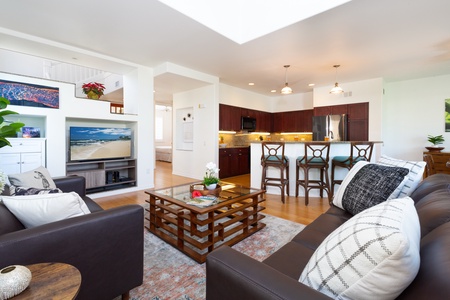 - Relax in comfort with a spacious seating area and flat screen TV perfect for movie nights - Elegant wood finishes and accent rug bring warmth to this airy room - Open sight lines connect the living room seamlessly to the kitchen