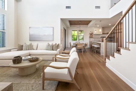 Unwind in your elegant open-concept living space, where warm wood floors and modern furnishings create the perfect retreat.