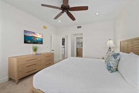 Drift off in your peaceful retreat with plush bedding, coastal decor, and soothing ocean artwork creating the perfect ambiance for rest.