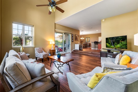 Spread out in your spacious living room with vaulted ceilings, elegant hardwood floors, and plush seating perfect for gathering. Natural light pours in, and your patio awaits just beyond the glass door.