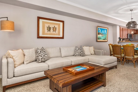 Sink into this plush sectional sofa where coastal artwork and warm wood accents create your perfect retreat for relaxation and conversation.