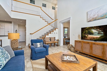 Living room with vaulted ceiling and tall windows