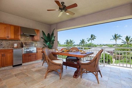 - Outdoor dining space with tropical views and ceiling fan for comfort   - Woven chairs around a polished wooden table create a relaxed vibe   - Built-in grill and lush greenery make this spot ideal for alfresco meals