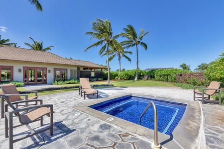 Private tropical paradise with sparkling hot tub surrounded by swaying palms and manicured grounds under endless blue skies.