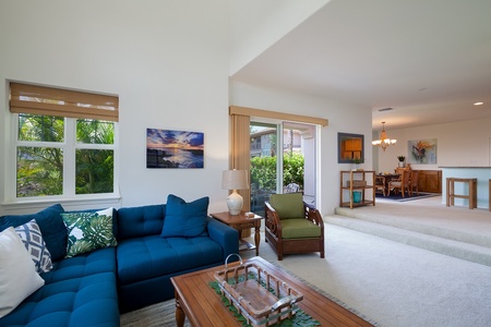 - Spacious open concept layout connects the living room, patio, and dining area seamlessly - Rich wood furnishings and island accents blend comfort with coastal elegance - Natural light pours through windows and glass doors to keep things bright