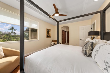 Wake up in your elegant canopy bed to tropical views through large windows, where comfort meets paradise in this peaceful retreat.