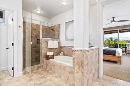 Ensuite primary bathroom with double vanity, walk-in shower, and soaking tub