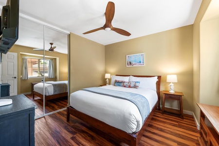 Your peaceful bedroom retreat features warm wood tones, crisp linens, and a stylish ceiling fan to keep you comfortable during your stay.
