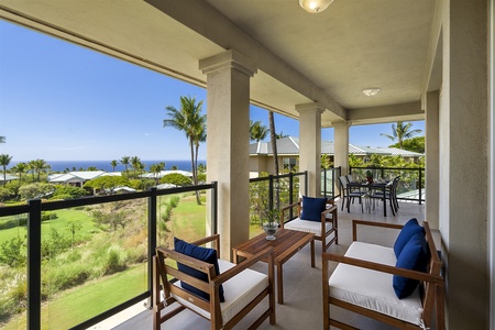 - Spacious covered balcony with wooden lounge seating and ocean vistas   - Multiple seating areas provide spots for conversation and relaxation   - Surrounded by tropical landscapes and refreshing coastal breezes