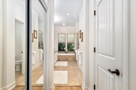 Step into your spa-like bathroom retreat with a luxurious soaking tub, elegant tile work, and garden views for ultimate relaxation.