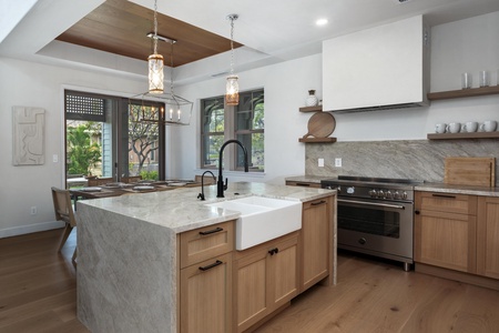 Your gourmet kitchen features marble countertops, warm wood cabinetry, and top-tier appliances, creating the perfect space for memorable meals.