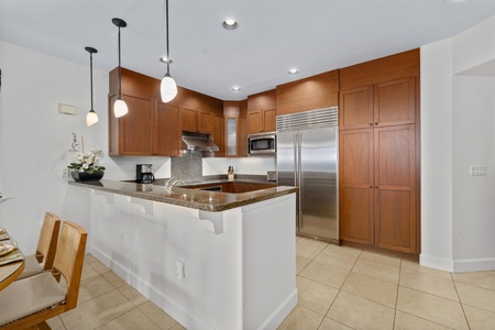 Your gourmet kitchen awaits with granite counters, stainless steel appliances, and a breakfast bar perfect for morning coffee or evening conversations.