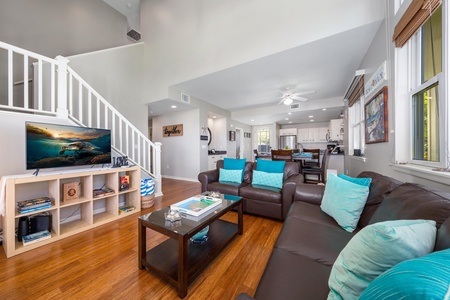 - Spacious lounge with warm wood floors and cozy seating perfect for family time - View extends from entertainment area to dining and kitchen for easy flow - Neutral tones mixed with aqua accents create a peaceful vacation atmosphere