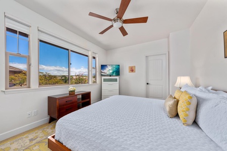 - Relax in this bright bedroom with a king size bed and crisp white linens - Enjoy the natural light and beautiful views through large windows - Watch your favorite shows on the wall mounted smart TV near the dresser