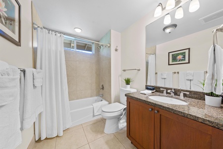 Your spacious bathroom features a relaxing soaking tub, granite countertops, and crisp white linens for ultimate comfort.