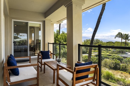 - Covered balcony with wooden seating set against stunning tropical views   - Glass railing ensures unobstructed scenery of ocean and gardens   - Ideal for enjoying morning coffee or a relaxing afternoon drink