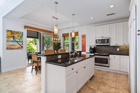 Full kitchen with breakfast bar, granite counters, and modern appliances