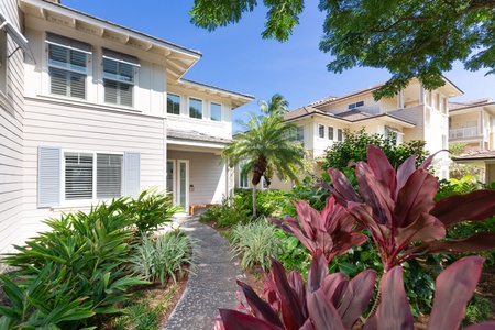 Garden pathway leading to the home with vibrant plants.