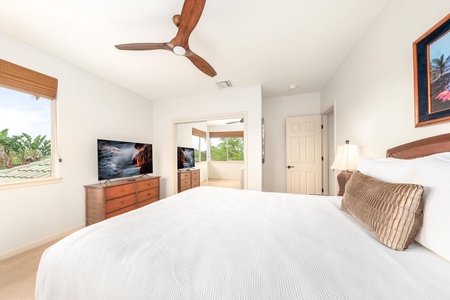 Unwind in your bright, airy bedroom with tropical ceiling fan, flat-screen TV, and peaceful garden views through bamboo blinds.