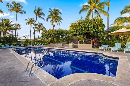 The sparkling blue pool awaits with plenty of lounge chairs.