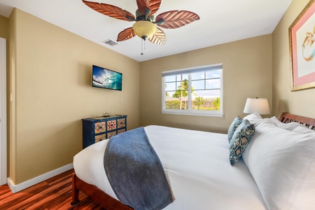 Sink into crisp white linens and wake up to gentle natural light streaming through your window. The tropical ceiling fan and cozy reading lamp make this space your perfect retreat after a day of adventure.