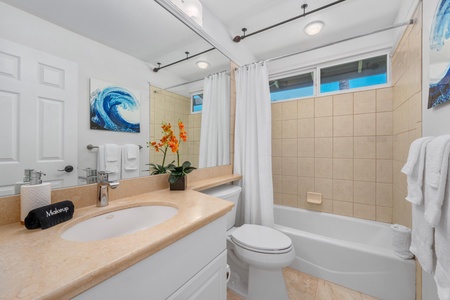 Guest bathroom with a full tub and shower combo.