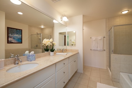 - Spacious bathroom with double vanity, stone countertops, and plenty of cabinet storage - Walk in shower and large mirror make getting ready easy for two - Fresh flowers, fluffy towels, and a clean layout give it a stylish hotel feel