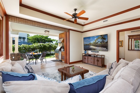 - Indoor lounge with plush sectional sofa, ceiling fan, and large flat screen TV   - Open wall design connects seamlessly to outdoor dining and kitchen area   - Perfect for relaxing while staying connected to the fresh island air