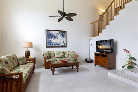 Living room with vaulted ceilings and tall windows