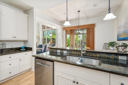 You'll love cooking in this bright, open kitchen with granite counters, pendant lighting, and views of the lush garden beyond.