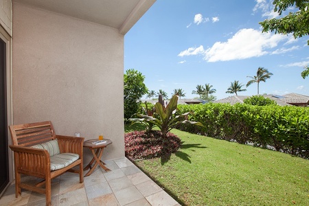 - Cozy patio nook with cushioned chair and small side table for morning coffee   - Beautiful green lawn and tropical plants create a serene outdoor retreat   - Open air setting offers privacy while still enjoying the sunshine and breeze